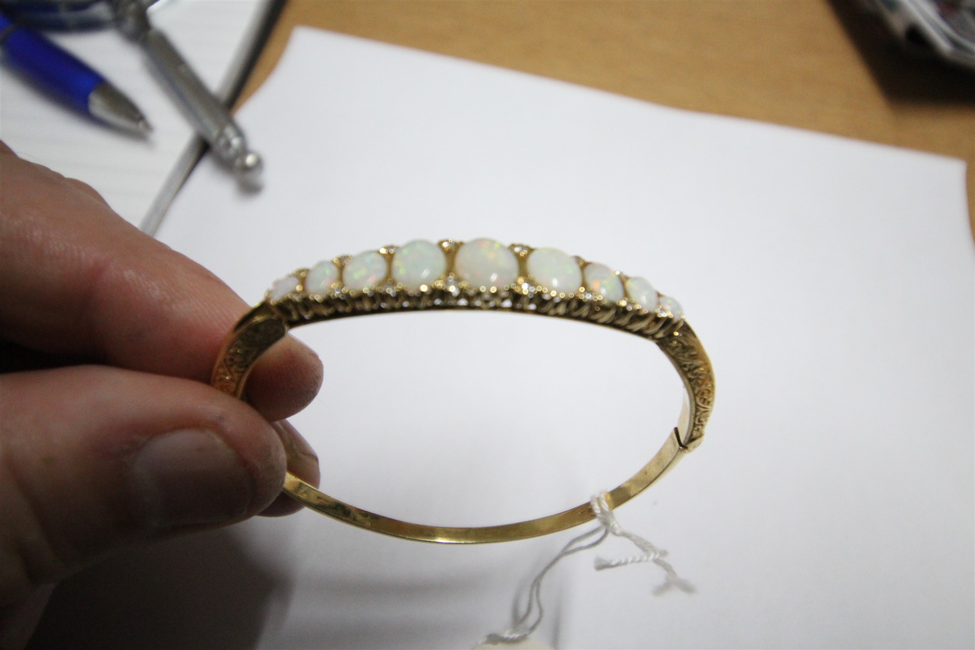 Lot 239 - 18ct Gold Bangle with 9x Stones - £600